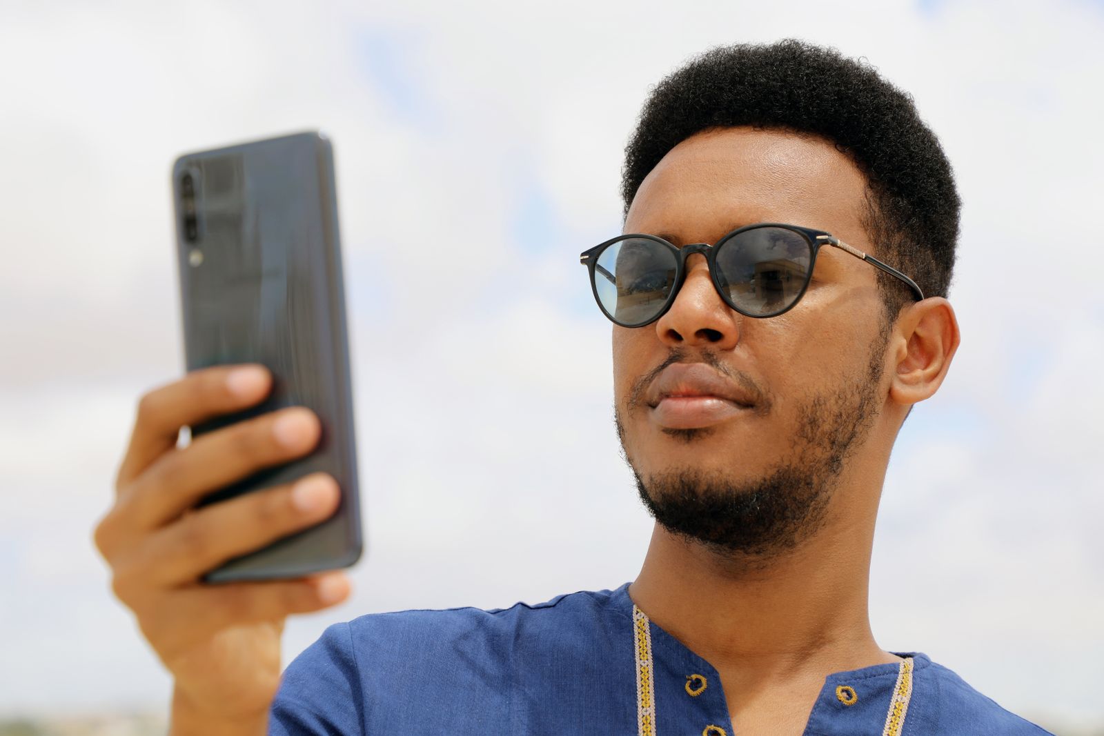 A man using a mobile phone outdoors